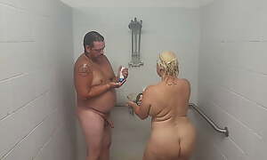 Husband and wife taking a shower with a quickie.