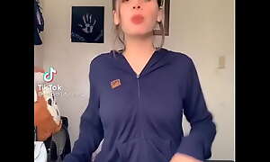 Youthful beauty dances seductively in the matter of selfish shorts, teasing inviting curves with playful energy.